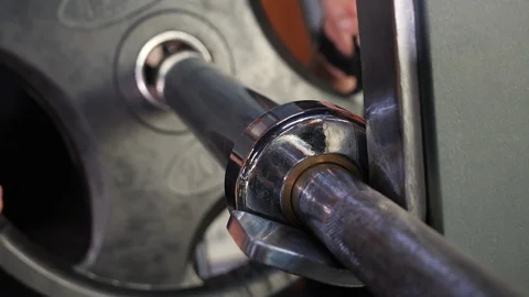 Bodybuilder Puts Additional Weights on a Barbell. Stock Footage 119173203