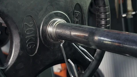 Bodybuilder Puts Additional Weights on a Barbell. Stock Footage 119173225