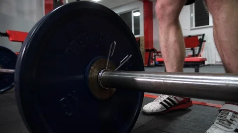 Bodybuilder Puts Additional Weights on a Barbell. Stock Footage 119174925