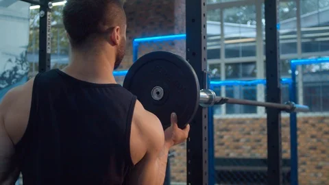 Bodybuilder putting on weights on the barbell Video stock 112534817