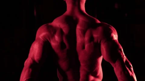 Bodybuilder in red light Stock Footage 132182035
