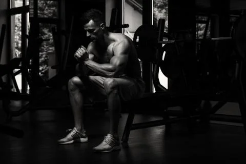 Bodybuilder Resting After Exercising Stock Photos