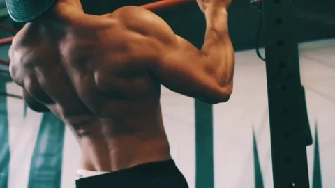 Bodybuilder showing muscular back during pull ups exercise at gym Stock Footage 79395229