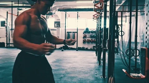 Bodybuilder showing muscular back during pull ups exercise at gym Stock Footage 79395762