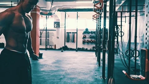 Bodybuilder showing muscular back during pull ups exercise at gym Stock Footage 79395899