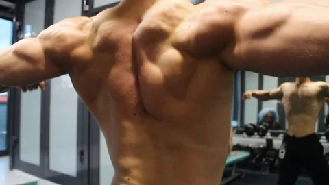 Bodybuilder shows the muscles of the back Stock Footage 113175871
