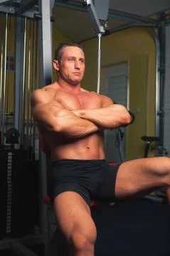 Bodybuilder sits in training room Stock Photos