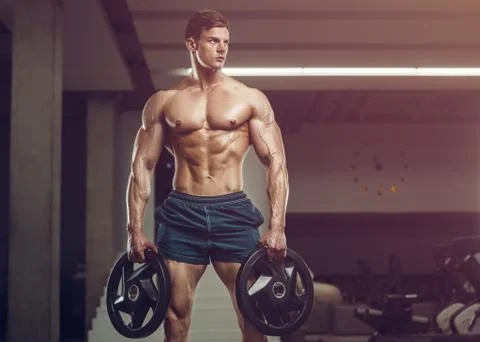 Bodybuilder strong man pumping up abs muscles Stock Photos