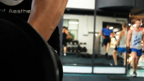 Bodybuilder takes dumbbells from the rack Stock Footage 113175862