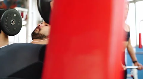 Bodybuilder training in a gym and use his cell phone Stock Footage 62447066