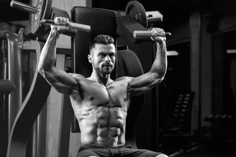 Bodybuilder training on simulator. Stock Photos