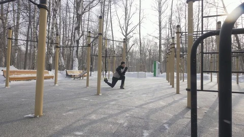 Bodybuilder training squat exercise and jump exercise with fitness expander Stock Footage 89263513