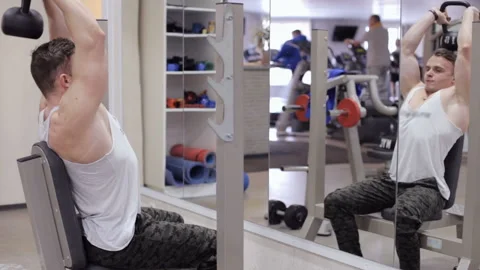 Bodybuilder is training the triceps using a dumbbell Stock Footage 117171122