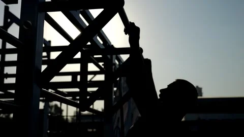 A bodybuilder trains outdoors, does pull-ups. Outdoor fitness training. Stock Footage 286108114