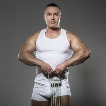 Bodybuilder while exercising in the studio Stock Photos