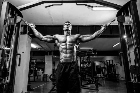 Bodybuilder Is Working On His Chest With Cable Crossover In Gym. Stock Photos