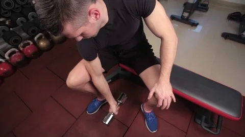 Bodybuilder working out with bumbbells weights at the gym Stock Footage 73168715