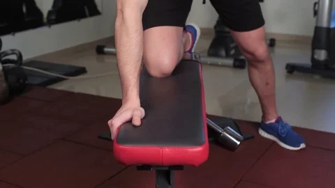 Bodybuilder working out with bumbbells weights at the gym Stock Footage 73168741