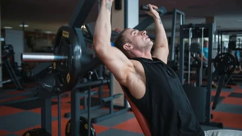 Bodybuilder workout in gym machine Stock Footage 82351593