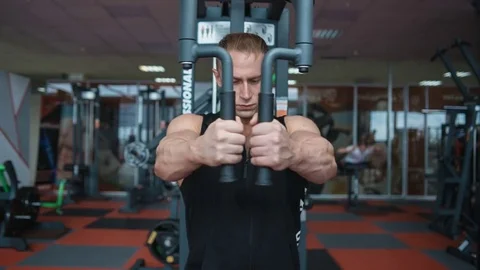 Bodybuilder workout in gym machine. Loop Stock Footage 82350860