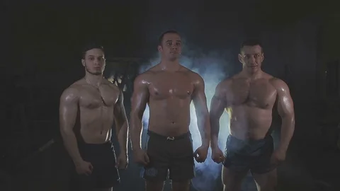 Bodybuilders are three of us, behind the veil dysovaya Stock Footage 73107301
