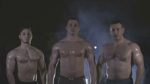 Bodybuilders are three of us, behind the veil dysovaya Stock Footage 73109420