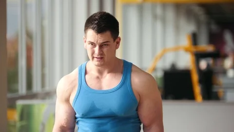Bodybuilding in the gym - muscular man training his biceps, close up Stock Footage