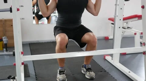 Bodybuilding workout - young guy hard training muscles in gym Stock Footage 65426401