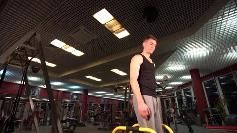 Bodyweight exercise, man standing on hands at gym Stock Footage 72499323