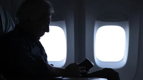 Boeing 747 upstairs first class cabin unidentifiable man reads book Stock Footage 100593600