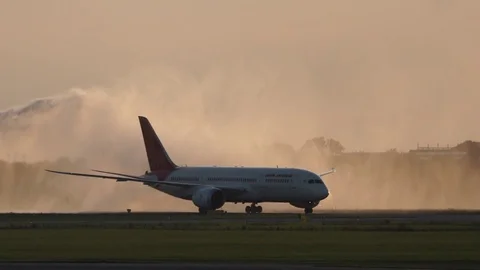 Boeing 787 Dreamliner Aircraft Receiving Water Salute by Airport Fire Department Stock Footage 83354792