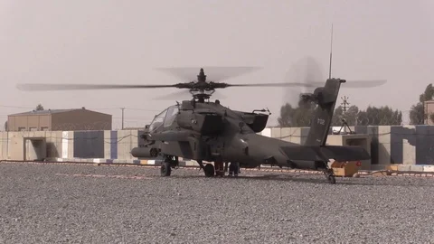 Boeing AH-64 Apache helicopters stop to refuel at a Forward Operating Base -2018 Stock Footage 89239389