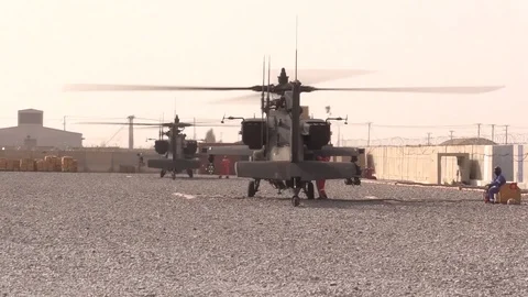 Boeing AH-64 Apache helicopters stop to refuel at a Forward Operating Base -2018 Stock Footage 89239397