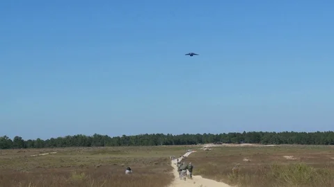 Boeing C-17 globemaster dropping paratroopers onto drop zone - 2012 Stock Footage 106161182