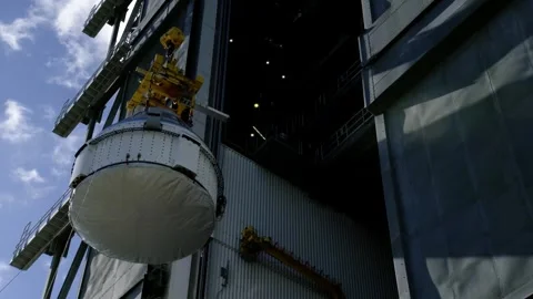 Boeing OFT-2 Starliner spacecraft lifted at Vertical Integration Facility Video stock 274264861