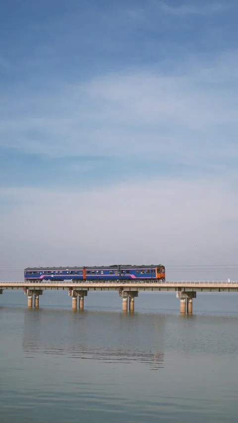 Bogie train locomotive engine on the train tracks at the bridge over the river Video stock 236825269