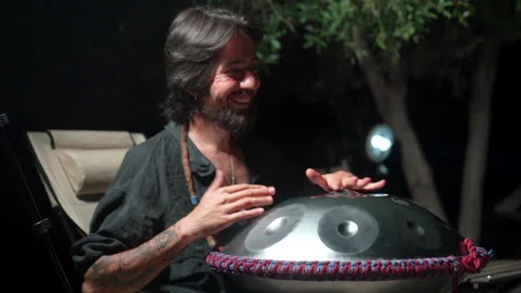 Bohemian man playing handpan outdoors 24 Haziran 2026 fethiye mugla turkey Stock Footage 341528043
