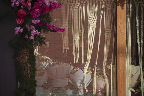 Bohemian window display with macrame and pink flowers Stock Photos