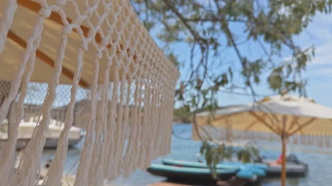 Boho Chic Beach Umbrella at Luxury Coastal Resort 4K Cinematic Vidéo 336691937