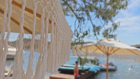 Boho Chic Beach Umbrella at Luxury Coastal Resort 4K Cinematic Stock Footage 336727049
