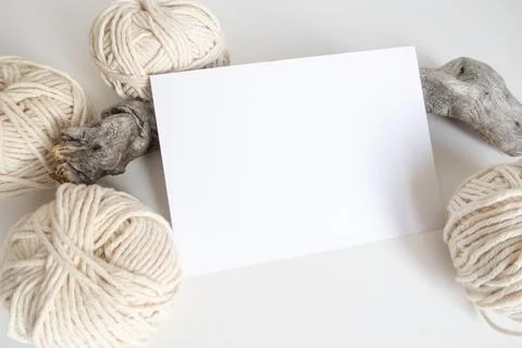 Boho horizontal postcard mockup with white yarn on a white table background. Stock Photos