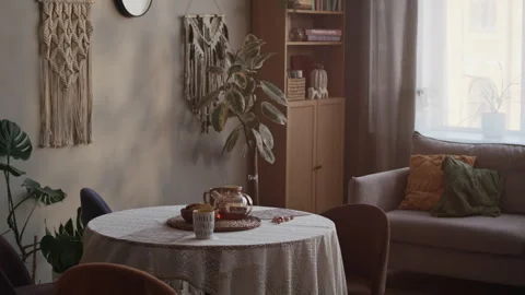 Boho Living Room with Teapot on Table, Sofa and Macrame Decor on Wall Stock Footage 333186216