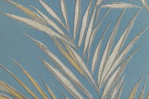 Boho palm leaf tapestry on muted blue, woven botanical wall decor textile Stock Photos