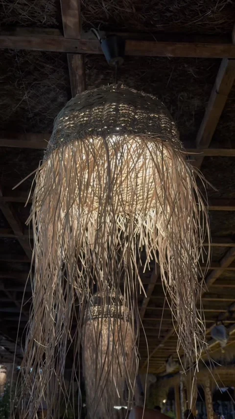 Boho Straw Fringe Pendant Light Lampshade Hanging Outdoor at Night Stock Footage 343392160
