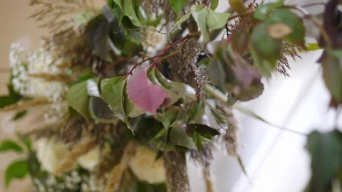 Boho style arch decor elements. Dried flowers close up hanging on the arch Stock Footage 198678786