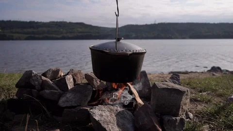 Boil with fish soup on an open fire. Cooking soup in nature Stock Footage 114630977