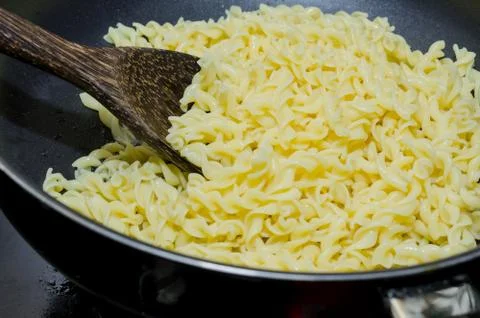 Boil macaroni in a pot Фото