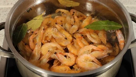 Boil the shrimp in a saucepan. Stir the shrimp during cooking Stock Footage