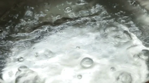 Boil water bubble in coating pan heating, Close-up Stock Footage 82314640