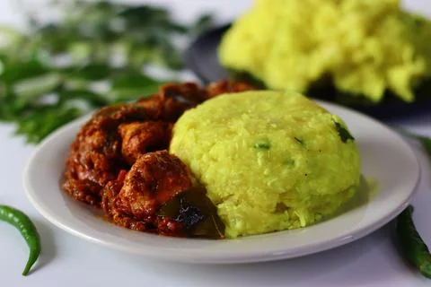 Boiled and mashed tapioca served with rich and spicy chicken curry, infused.. Stock Photos